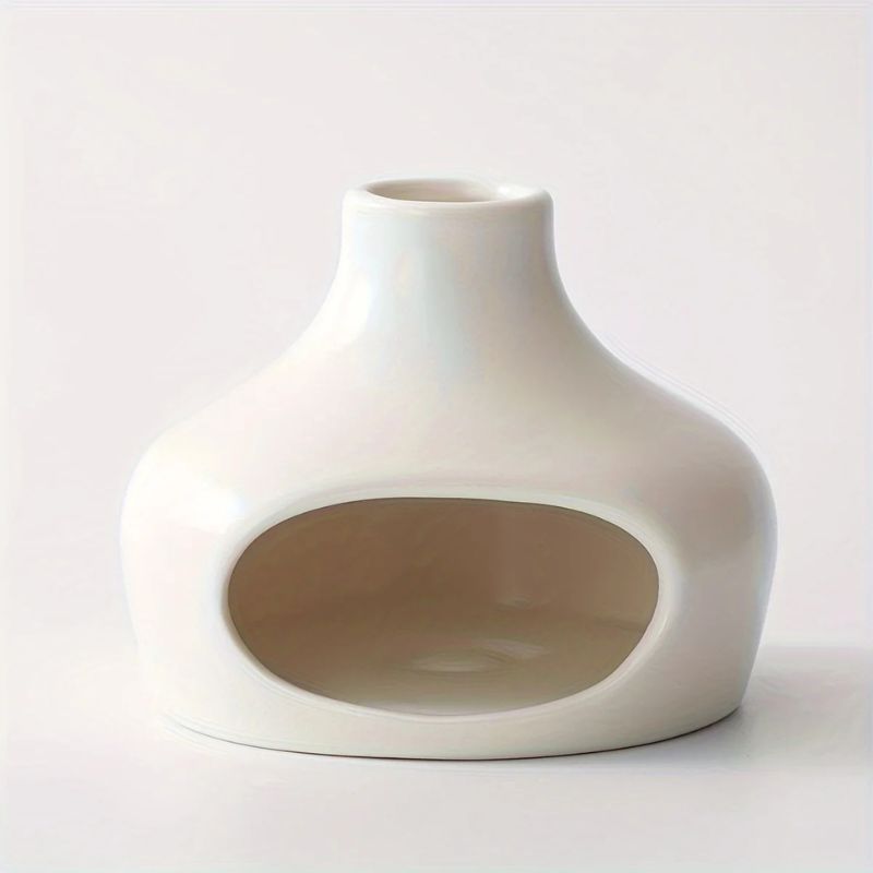 A white ceramic hideout with a rounded, bulbous shape, a narrow top opening, and a large front cutout. The surface is smooth and glossy, designed for small animals or decorative use.