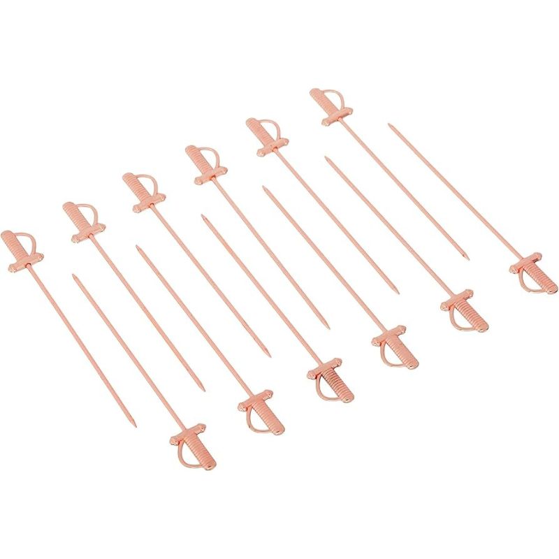 Ten rose gold stainless steel cocktail picks with small, sword-shaped toppers, arranged diagonally on a solid white background.