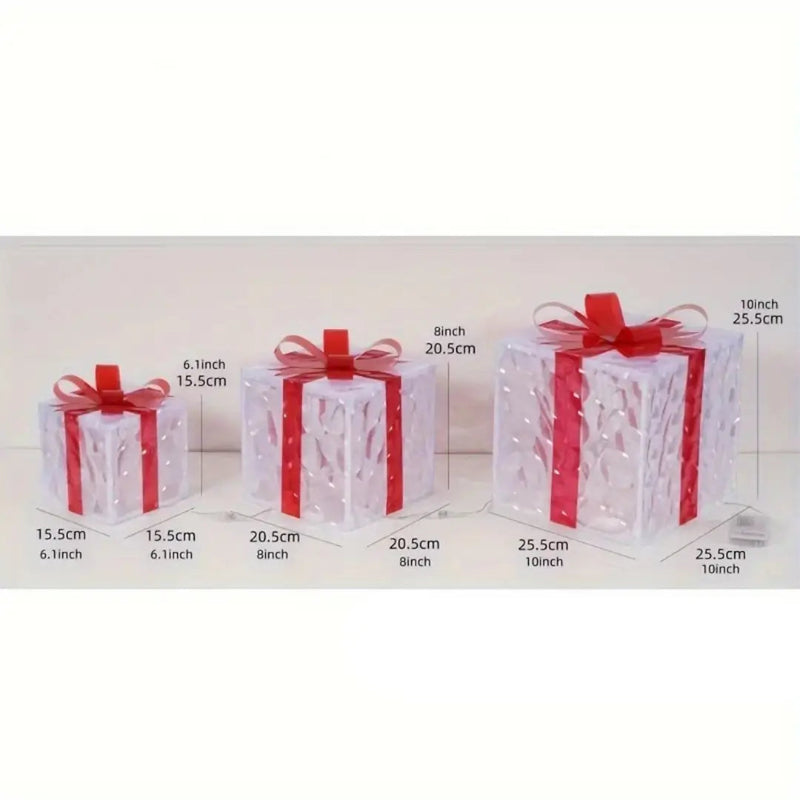 Three clear, decorative gift boxes with red ribbons, displayed with their dimensions in inches and centimeters.