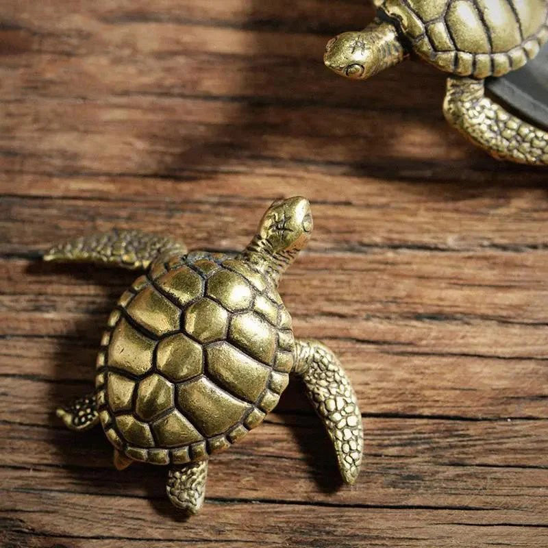 Bronze turtle figurines on a wooden surface
