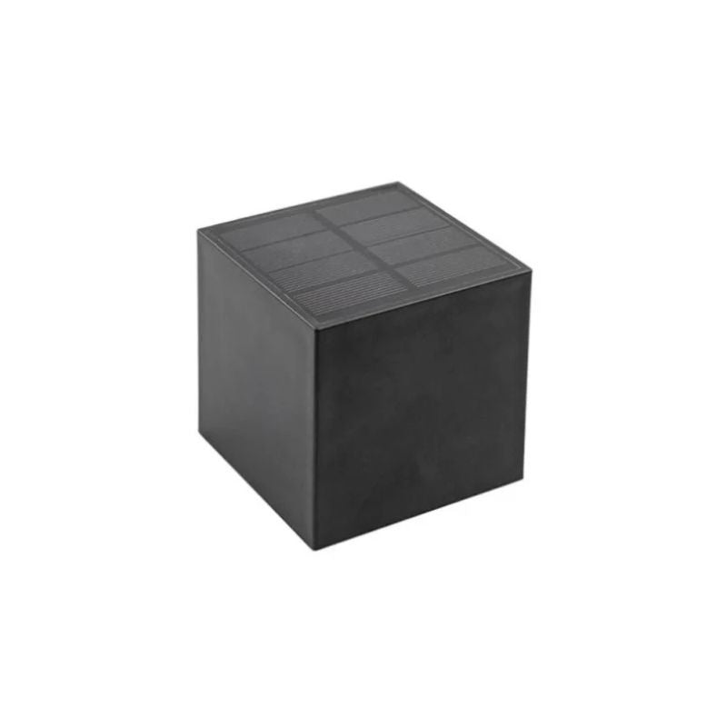 A black cube-shaped solar wall light with a minimalist design. The top surface features a solar panel for energy absorption, while the sides have a smooth matte finish. The light is isolated against a plain white background.