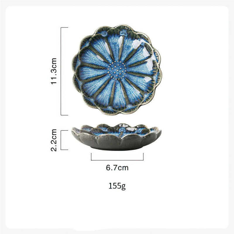 Dimensions diagram for a blue, flower-shaped condiment dish showing a length of 11.3cm, height of 2.2cm, bottom width of 6.7cm, and weight of 155g.