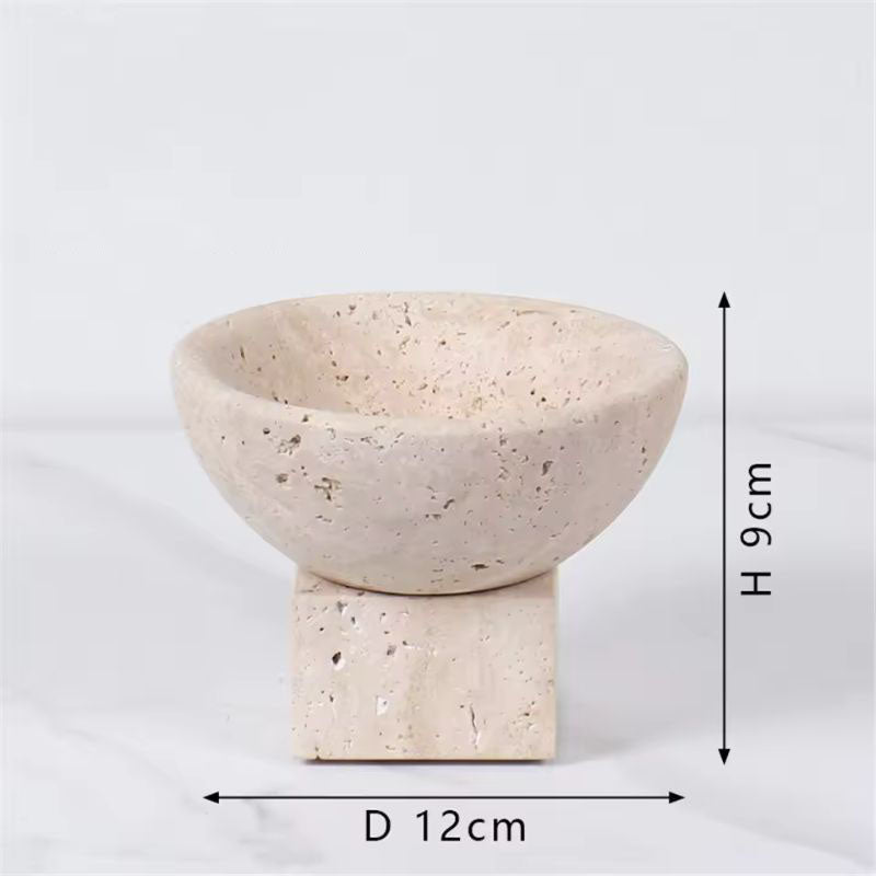 A small decorative bowl with a speckled texture, crafted from natural stone, sits atop a square stone base. Measuring 12cm in diameter and 9cm high, it serves as an elegant home accent against the plain white background.