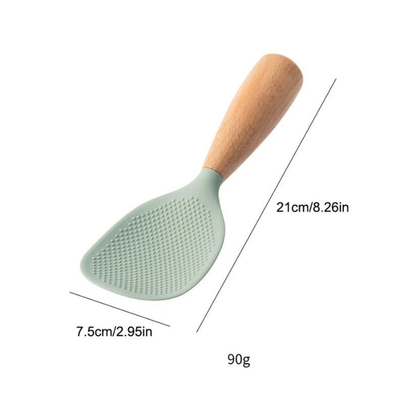 Green silicone rice paddle with a textured, non-stick surface and a wooden handle, featuring dimensions of 21 cm (8.26 in) in length and 7.5 cm (2.95 in) in width, weighing 90g.