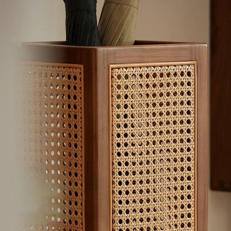 Close-up of a wooden umbrella stand with rattan panels.