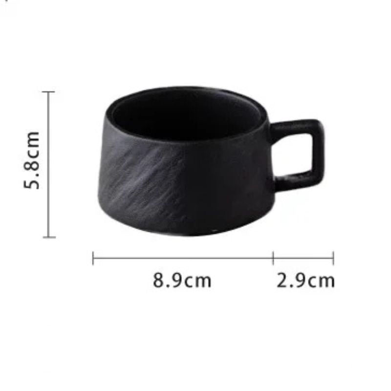 Black ceramic coffee cup with a textured rock-like surface, featuring a sturdy handle. The dimensions are 5.8 cm (2.3 inches) in height, 8.9 cm (3.5 inches) in diameter, and a 2.9 cm (1.1 inches) handle extension.