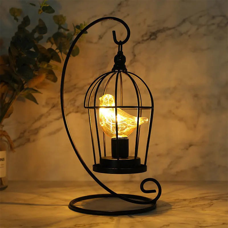 Decorative lamp with a birdcage design on a marble surface
