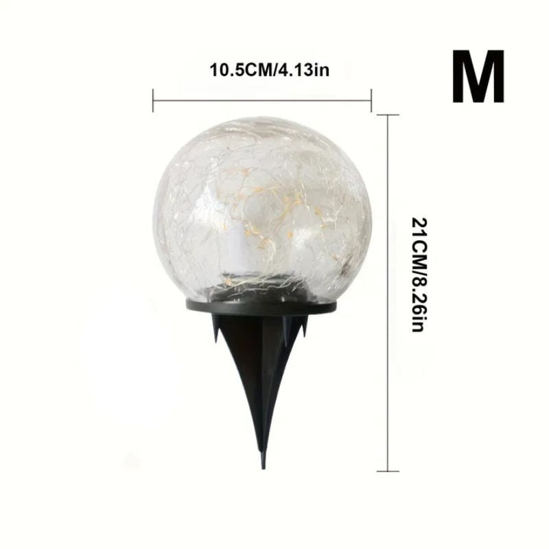 A medium-sized crackle glass solar garden light with a black ground stake. The dimensions are 10.5 cm (4.13 in) in width and 21 cm (8.26 in) in height. The letter "M" is displayed in the top right corner, indicating the medium size.