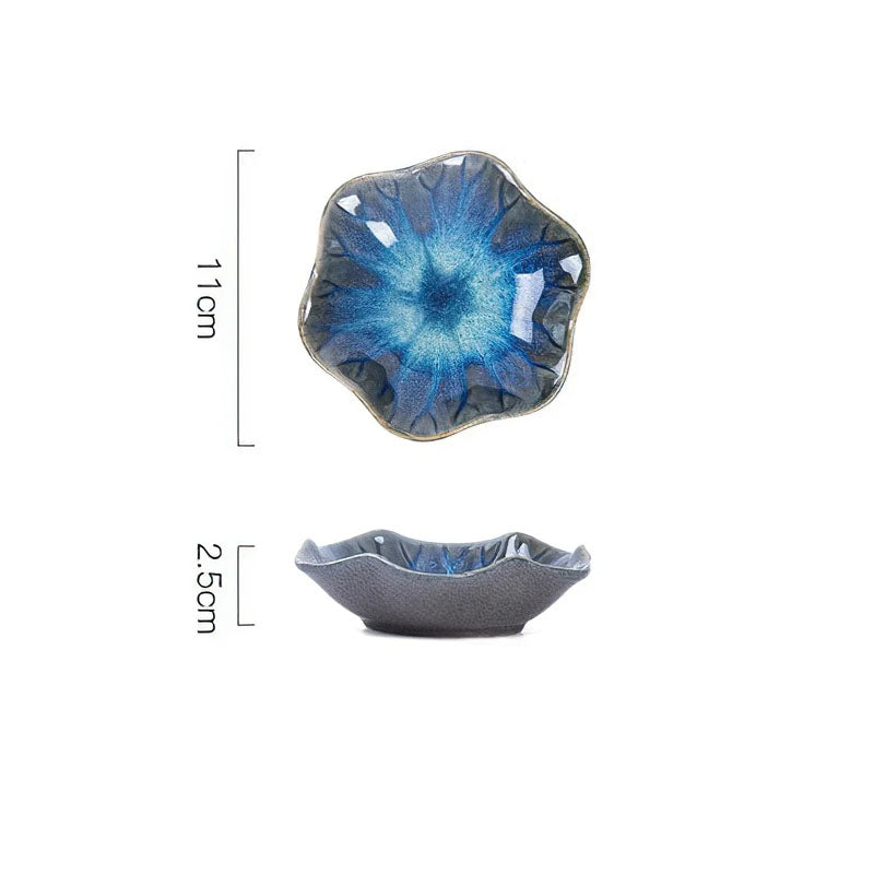 Dimensions diagram for a blue and grey flower-shaped condiment dish showing a length of 11cm and a height of 2.5cm.