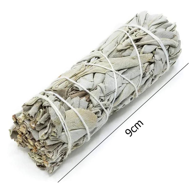 A straight-on shot of a bundle of dried white sage, tied with white string, lying diagonally across a white background. The sage bundle is the primary focus, showing its pale gray-green leaves and rough texture. A thin black line with the measurement "9cm" is shown running parallel to the length of the sage bundle, indicating its size.