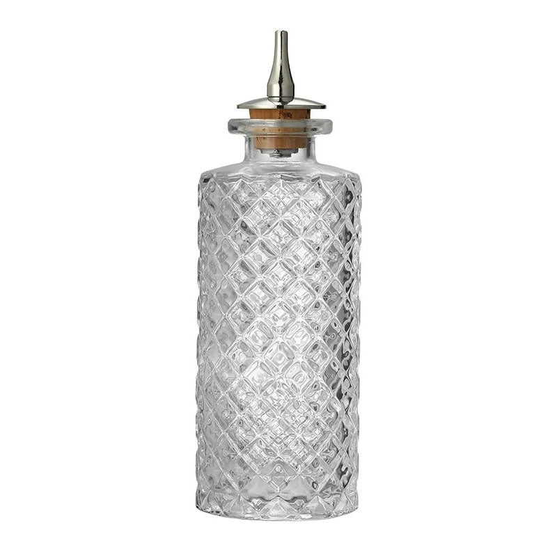 This bottle has a striking diamond-embossed texture covering its entire surface, providing both aesthetic appeal and a non-slip grip. The cylindrical body has a straight profile leading to a short, wide neck. The cork stopper and metal spout ensure controlled pouring and preservation of contents. Its vintage-inspired design makes it a stylish addition to any kitchen or bar setting.