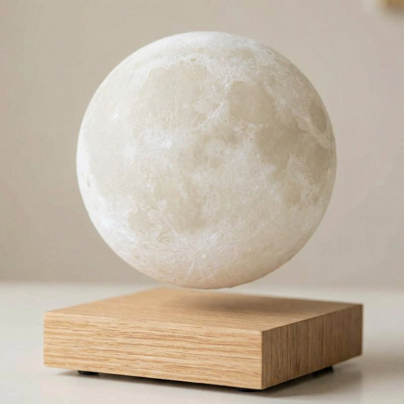 Levitating moon lamp on a wooden base against a neutral background