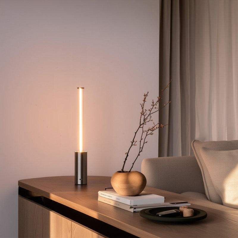 Modern interior with a table lamp, books, and decorative items on a wooden surface.