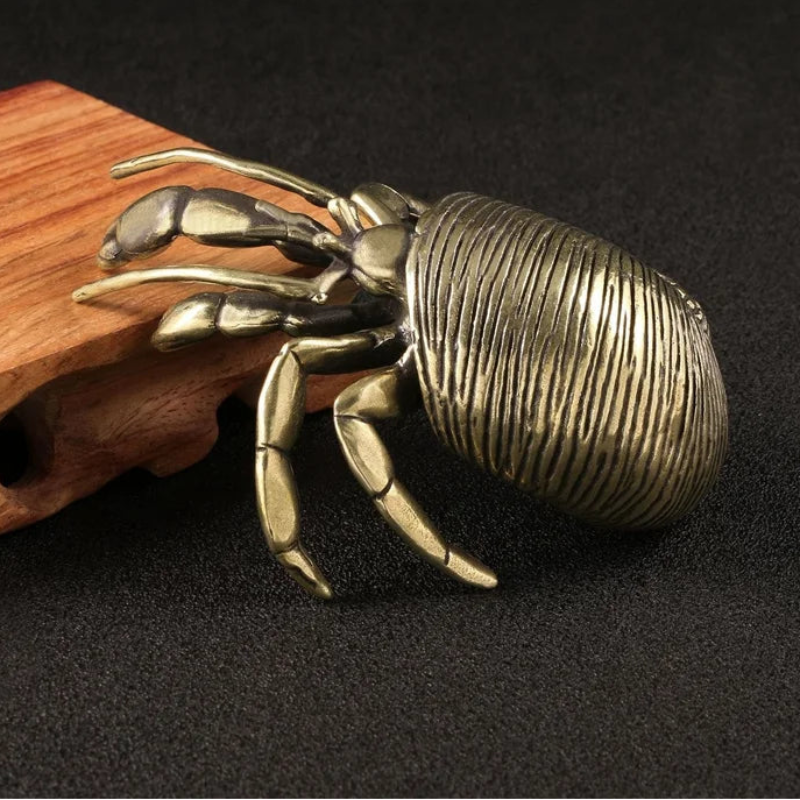 Bronze crab sculpture on a dark background