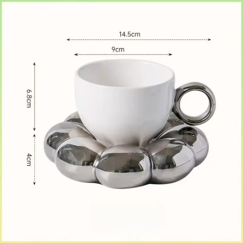 White ceramic coffee mug with a metallic silver cloud-shaped saucer, shown with dimension labels: 14.5 cm width, 9 cm cup diameter, 6.8 cm total height, and 4 cm saucer height.