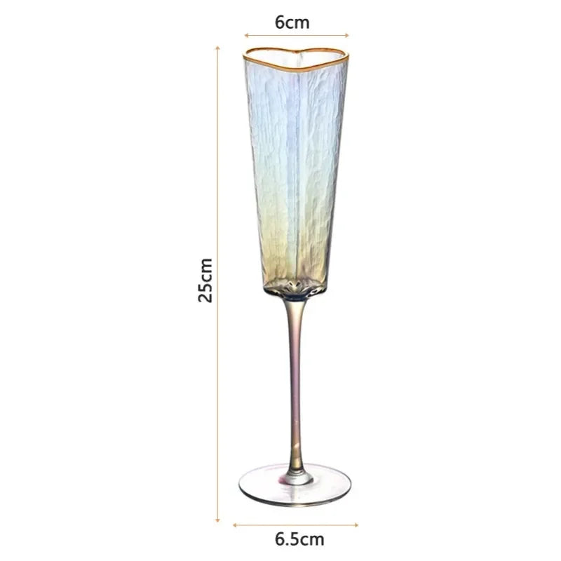 A single iridescent heart-shaped champagne flute with a gold rim, showing its dimensions: 25cm tall, 6cm wide at the top, and a 6.5cm base diameter.