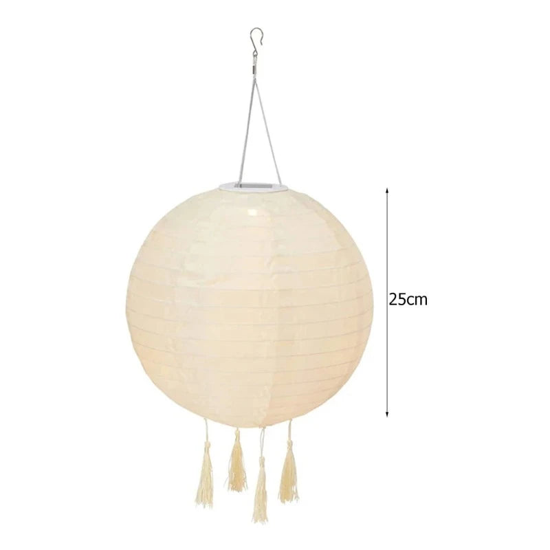 The image shows a white, round solar lantern with tassels, measuring 25cm.