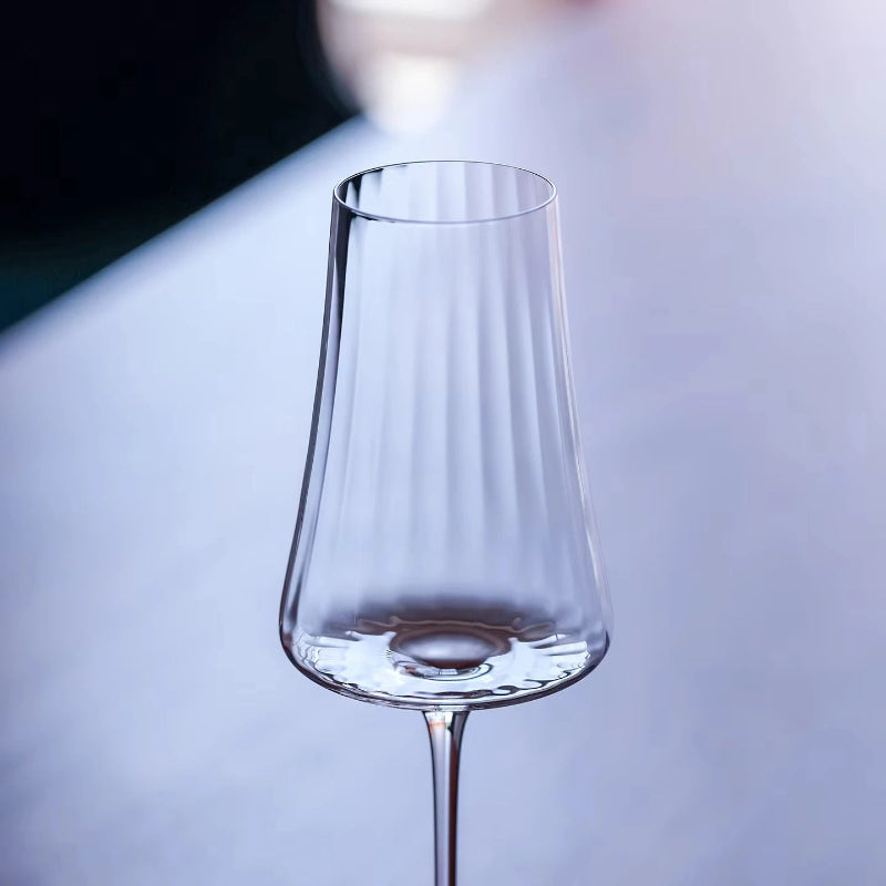 A tall, fluted wine glass.