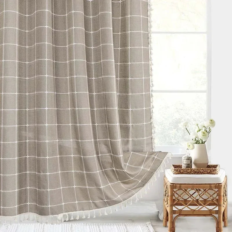 Window with a checkered curtain, white walls, and a small table with decor items.