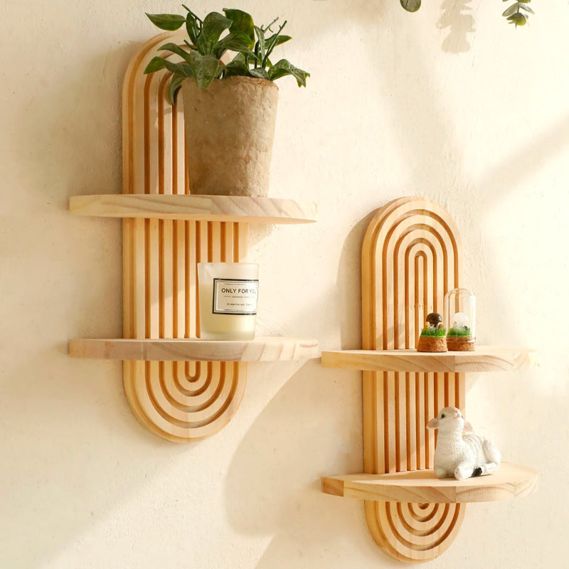 Boho geometric wooden wall shelf with natural wood finish mounted on white wall.