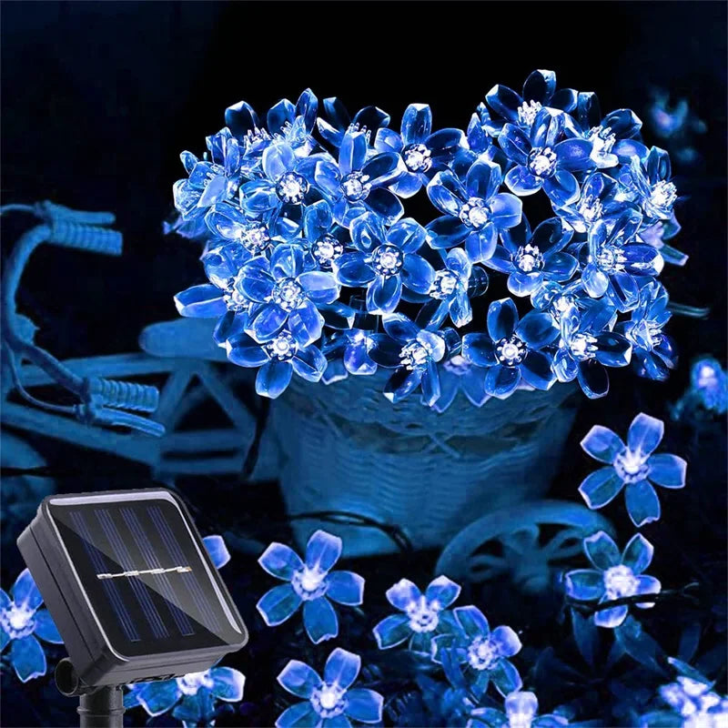 Solar-powered blue LED flower string lights in a basket.
