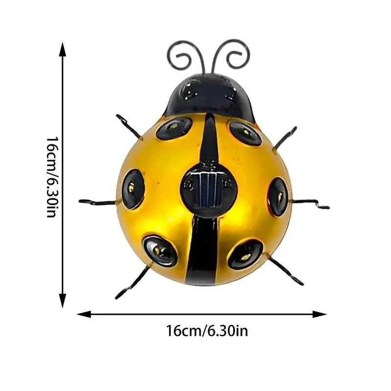 A diagram shows the dimensions of a decorative yellow and black metal ladybug solar light as approximately 16 cm/6.30 inches in both height and width. The ladybug has black antennae, six black legs, and embedded lights in its spots, with a solar panel on its back.