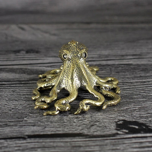 Bronze octopus figurine on a wooden surface