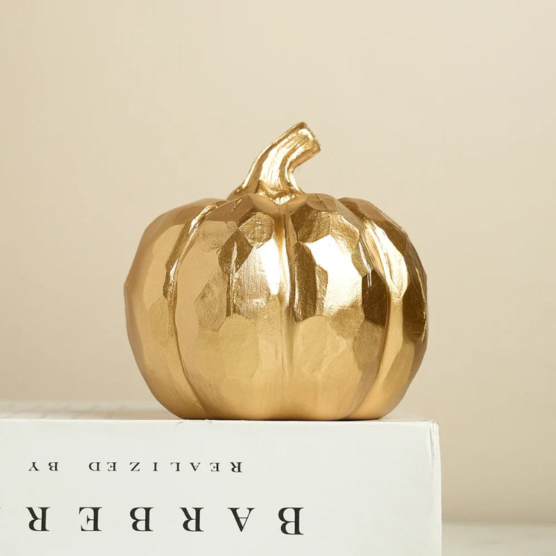 A decorative, faceted golden pumpkin.