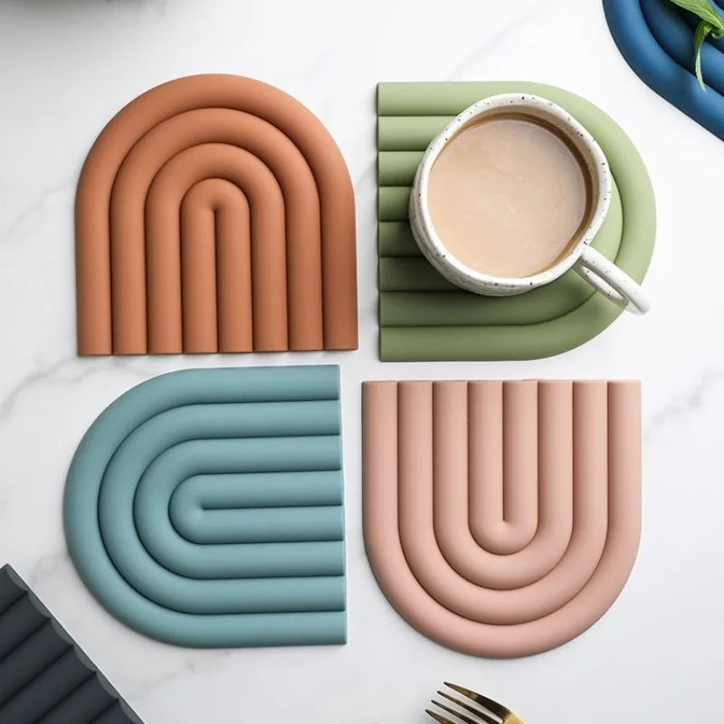 Flexible and heat-resistant silicone coasters in a rainbow design.