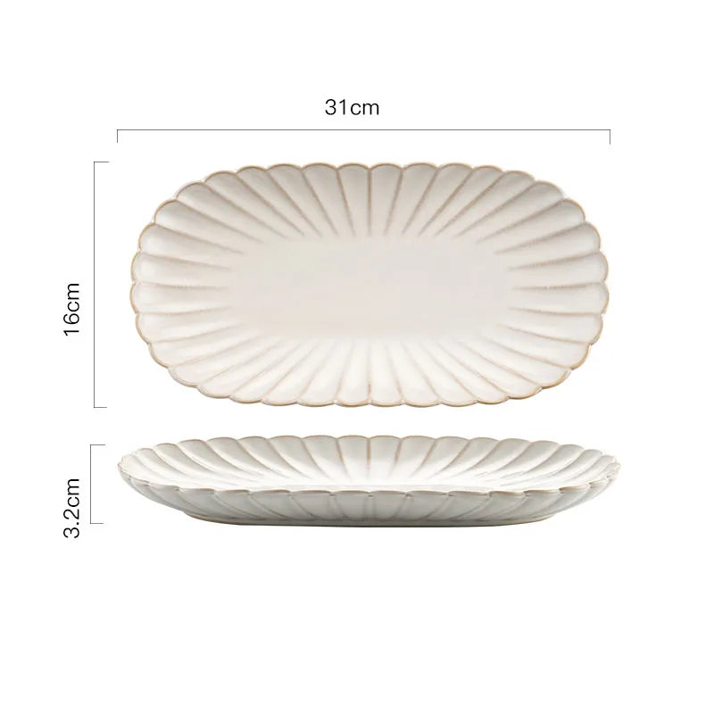 An oval ceramic serving platter with a scalloped edge and ribbed texture, measuring 31cm long, 16cm wide, and 3.2cm high.