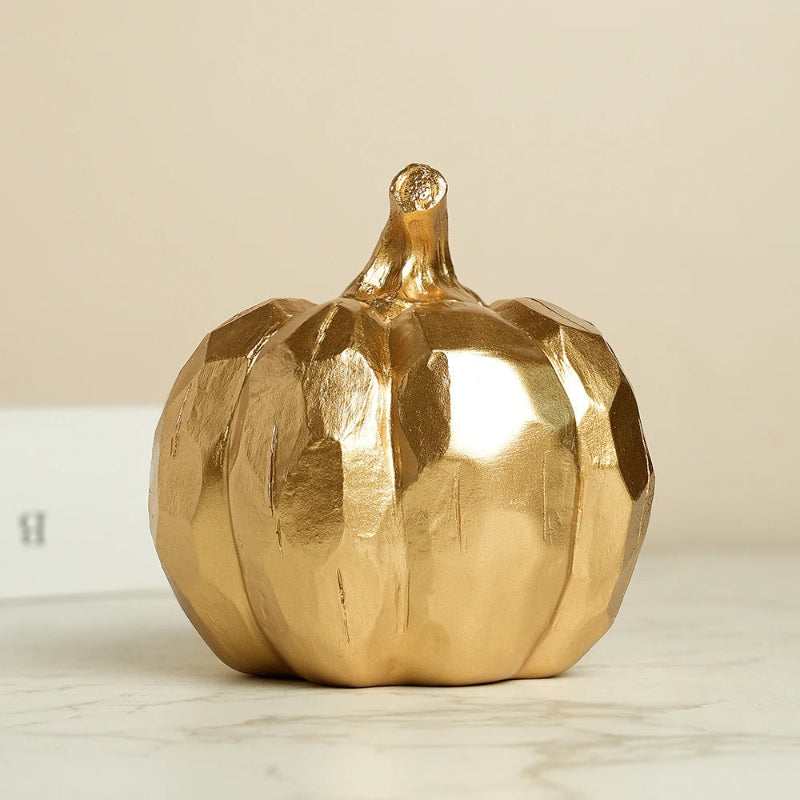 A golden, faceted decorative pumpkin.