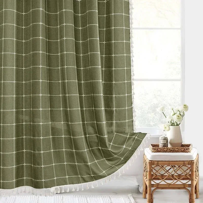 Green checkered curtain in a room with a small table and decorative items.
