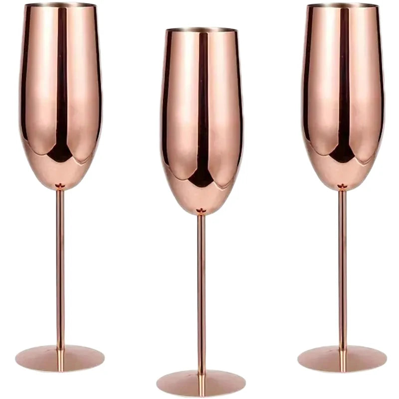 A set of three elegant rose gold stainless steel champagne flutes with a sleek, modern design, featuring a reflective finish and long, slender stems—perfect for special occasions and celebrations.