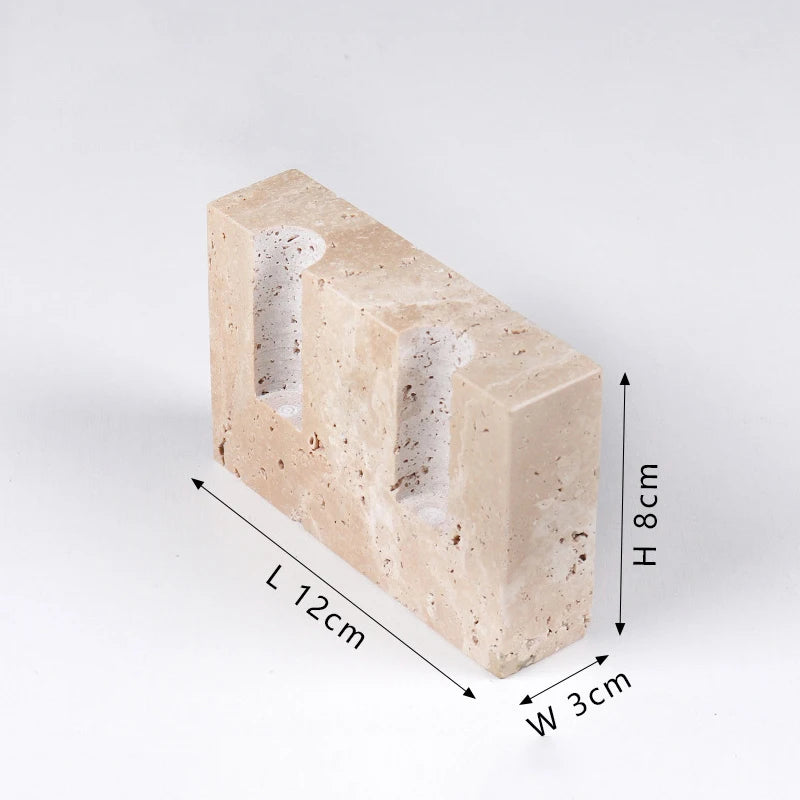 A rectangular block of textured, light-colored faux travertine stone with two cylindrical openings, shown with dimension indicators for length (L 12cm), width (W 3cm), and height (H 8cm).
