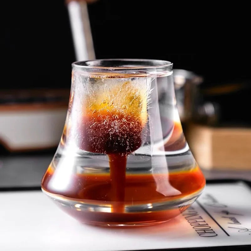 A stylish glass with a slow-melting coffee-infused ice cube, creating a rich swirl of flavors in the drink.