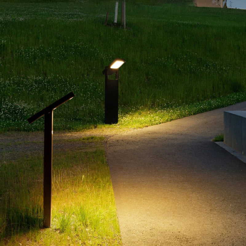 Adjustable solar pathway lights casting a warm glow along a curved outdoor walkway at night, featuring a sleek black design with rotatable LED heads.