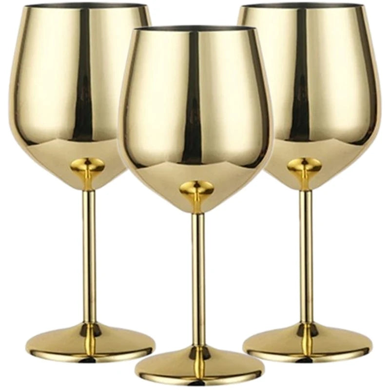A set of three stainless steel wine glasses with a luxurious gold polished finish, featuring a reflective surface, elegant long stems, and a modern design—ideal for upscale dining and special occasions.