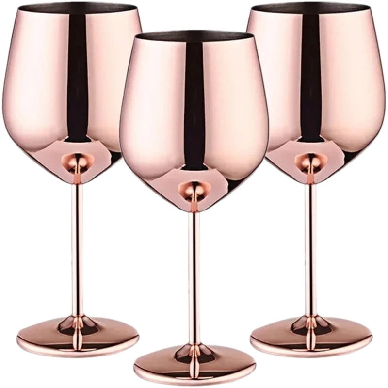 A set of three stainless steel wine glasses with a luxurious rose gold mirror finish, featuring a modern, reflective surface, elegant long stems, and a sophisticated design—perfect for stylish entertaining and upscale gatherings.