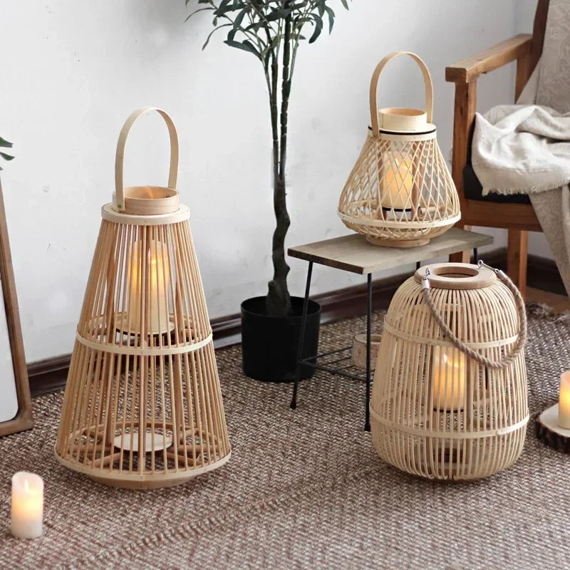 A cozy indoor setting featuring three Nordic woven bamboo lanterns, each with a distinct shape—Tower Light, Round Nest, and Barrel Glow. The warm candlelight inside the glass holders casts soft, flickering shadows, enhancing the ambiance. Placed on a table, floor, and rug, these handcrafted lanterns blend seamlessly with the modern, rustic décor.