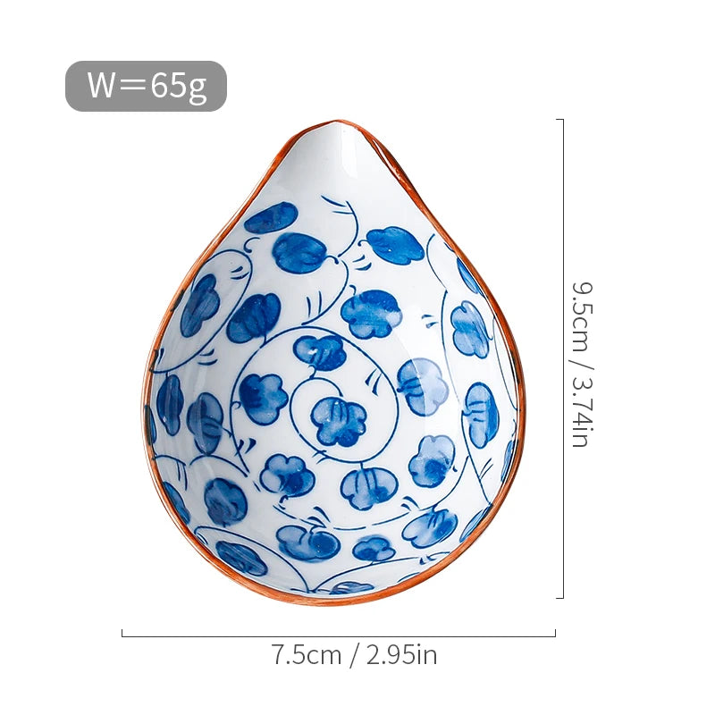 Hand-painted ceramic mini dipping dish with a blue floral pattern, teardrop shape, and orange rim. Measures 3.74 inches (9.5 cm) in height and 2.95 inches (7.5 cm) in width, weighing 65g.