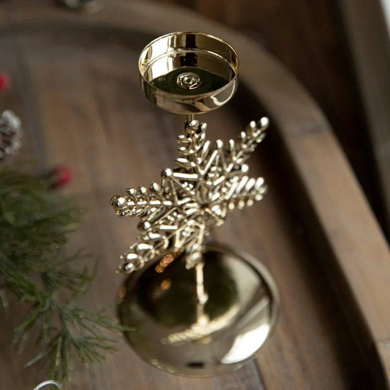 Shiny gold snowflake candle holder with a large gold ball base.