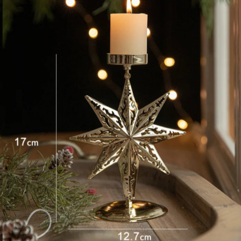 Lit candle in a gold star-shaped candle holder, with dimensions.