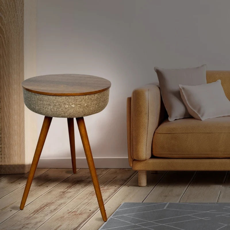 A stylish, mid-century modern end table with a built-in Bluetooth speaker sits next to a brown couch.