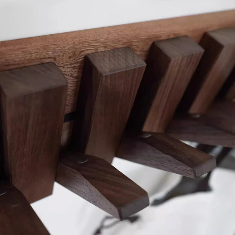 Wooden coat rack with multiple hooks on a white background