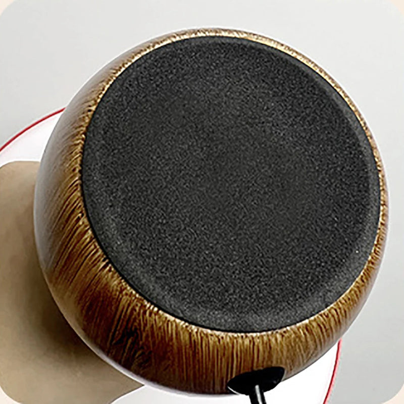 The circular, felt-covered base of a wooden lamp, viewed from below.