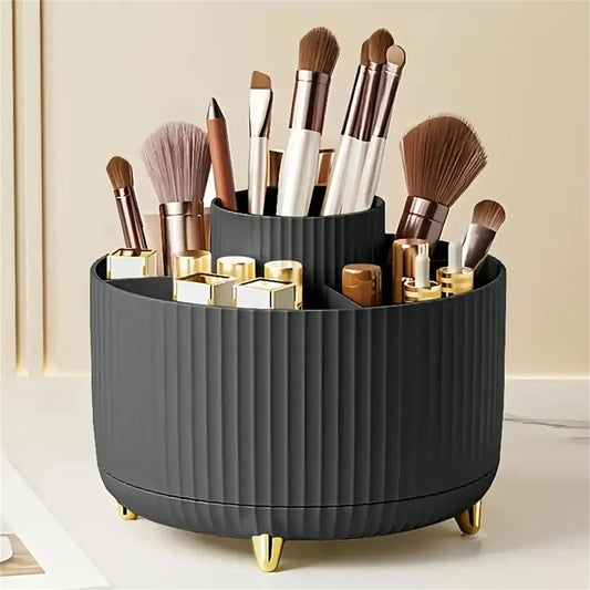 A charcoal grey, round makeup organizer with various brushes and cosmetic products.