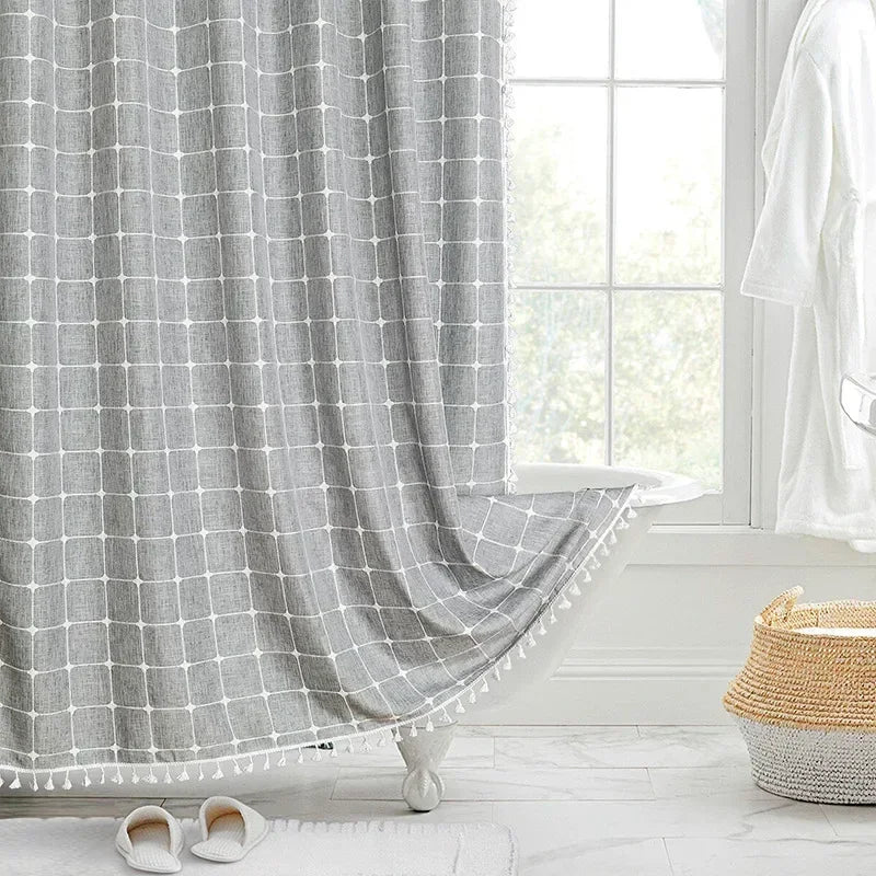 Gray checkered curtain with tassels in a bright room with a window and basket.