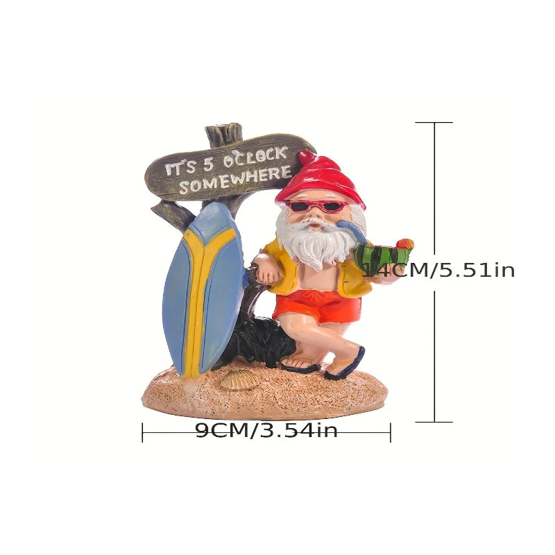 A whimsical garden gnome figurine is shown against a white background with dimension indicators. The gnome has a long white beard, wears red sunglasses and a pointed hat, a yellow shirt, and red shorts with sandals. He holds a slice of watermelon in one hand and a pipe in the other. Behind him is a rustic wooden sign reading "IT'S 5 O'CLOCK SOMEWHERE" attached to a blue and yellow surfboard. The base is sandy with small shells. Dimensions are indicated as 9cm/3.54in in width and 14cm/5.51in in height.