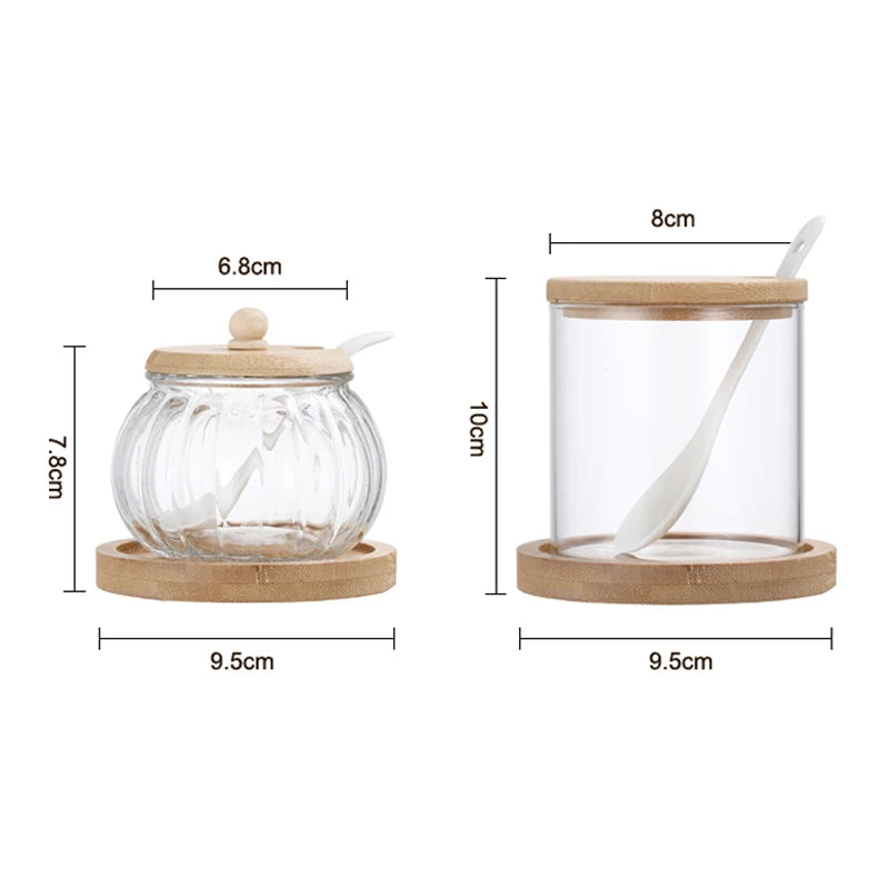 Two clear glass spice jars with wooden lids and spoons, showing dimensions.
