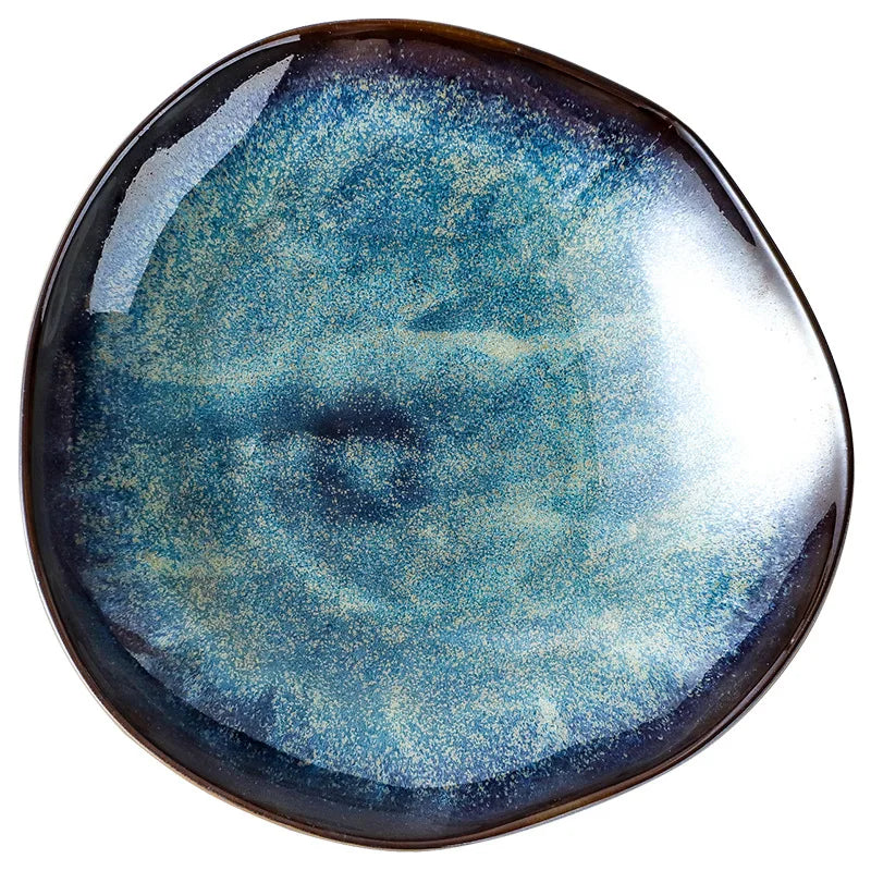 Ceramic plate with a blue and black abstract design on a white background